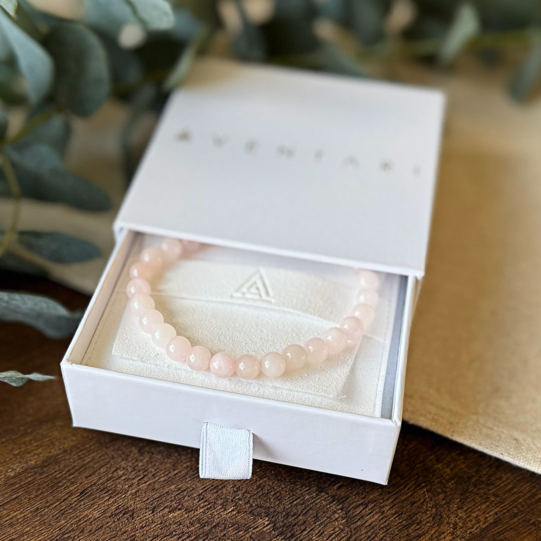 The delicate pink Rose Quartz Love Bracelet by Aventari displayed inside its white branded gift box for compassion and harmony.