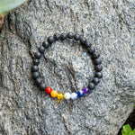 Lava rock bracelet base with a center ensemble of Red Agate, Orange Aventurine, Baltic amber, Amazonite, Blue Lace Agate, Lapis Lazuli and Amethyst, 6 mm beads.